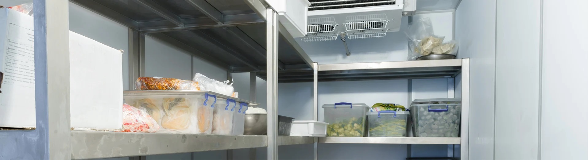 Industrial refrigeration unit with various items on shelves.